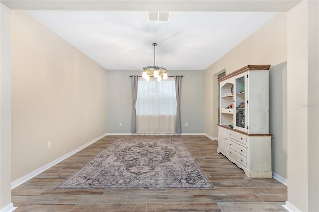 unfurnished dining area featuring an inviting chandelier