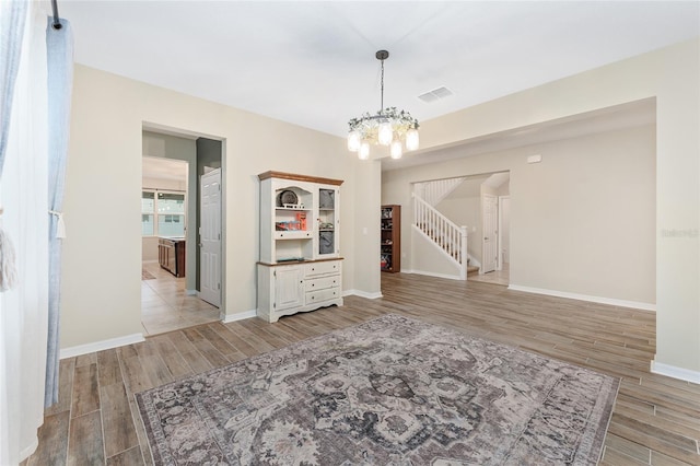 unfurnished dining area featuring a chandelier