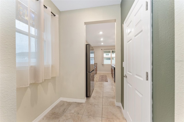 corridor featuring light tile patterned floors