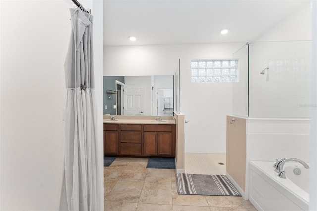 bathroom featuring tile patterned floors, vanity, and plus walk in shower