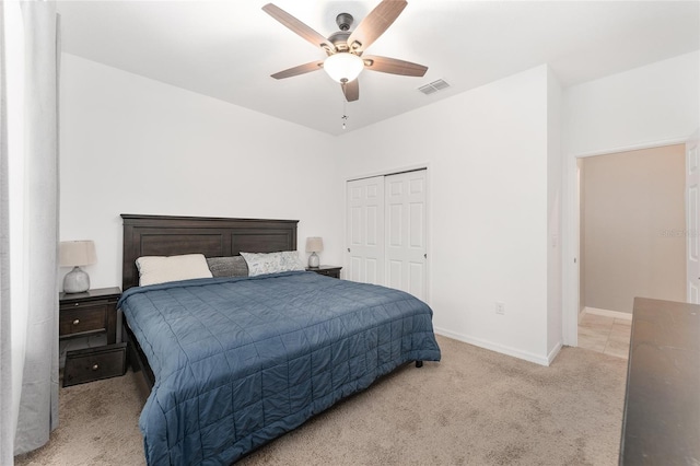 carpeted bedroom with ceiling fan and a closet