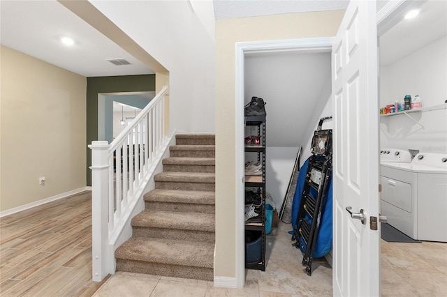 stairway featuring independent washer and dryer and a chandelier