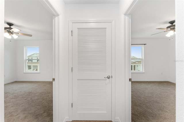 hall featuring light colored carpet