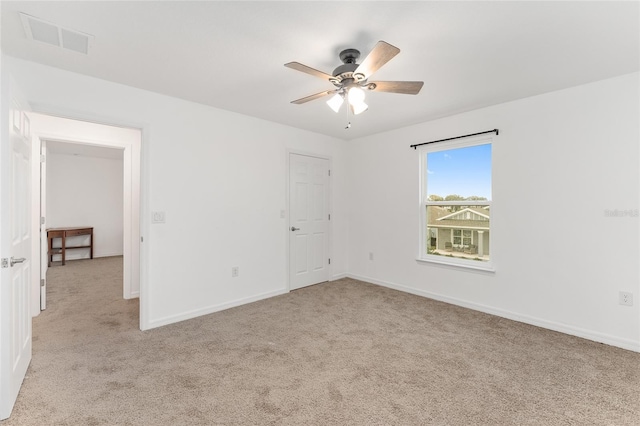 unfurnished room with ceiling fan and light colored carpet