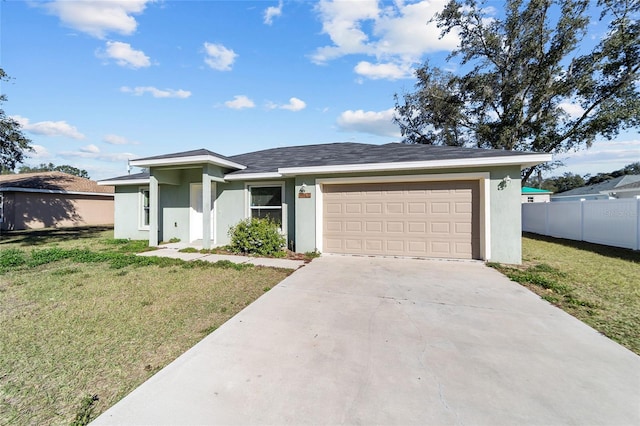 view of front of house featuring stucco siding, fence, concrete driveway, a front yard, and a garage