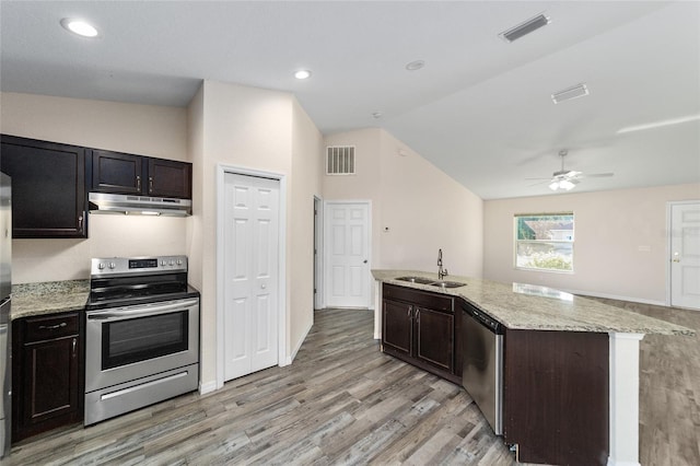 kitchen with visible vents, lofted ceiling, a sink, stainless steel appliances, and under cabinet range hood