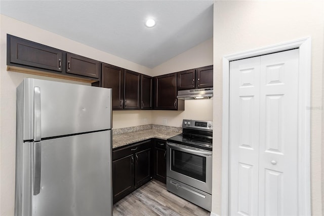 kitchen with light wood finished floors, lofted ceiling, dark brown cabinets, under cabinet range hood, and appliances with stainless steel finishes