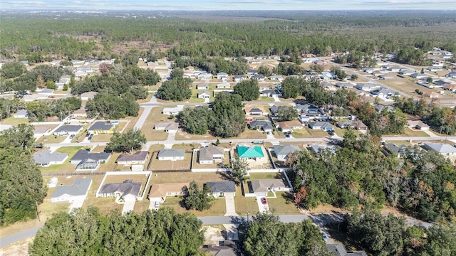 drone / aerial view with a residential view and a wooded view