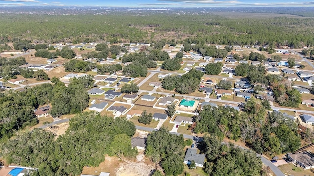 aerial view featuring a forest view and a residential view