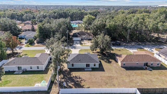 bird's eye view featuring a residential view and a wooded view