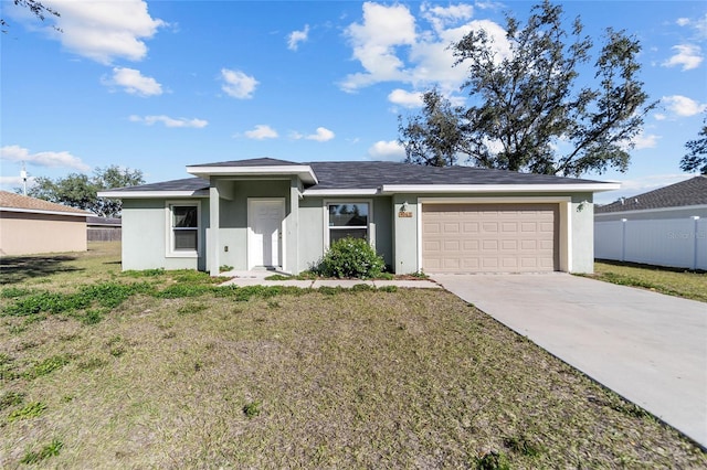 view of front of home with fence, stucco siding, concrete driveway, a front lawn, and a garage