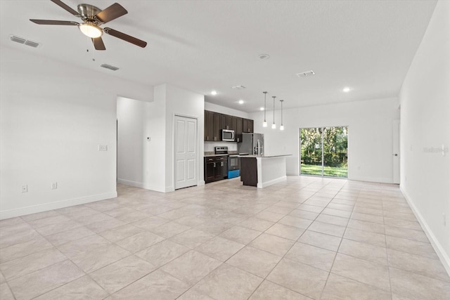 unfurnished living room featuring ceiling fan and light tile patterned floors