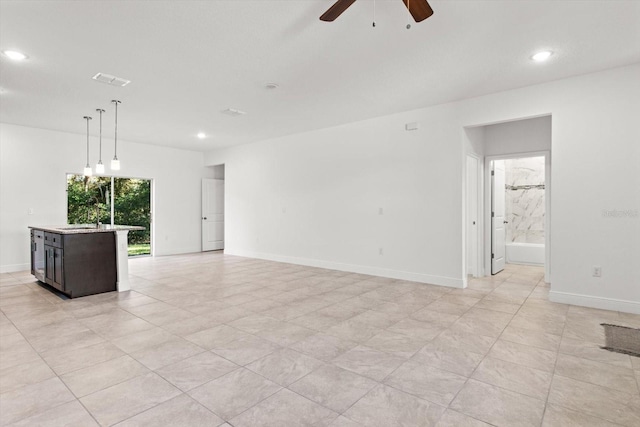 unfurnished living room with ceiling fan