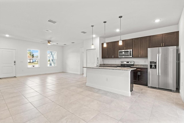 kitchen featuring dark brown cabinetry, appliances with stainless steel finishes, pendant lighting, and a center island with sink