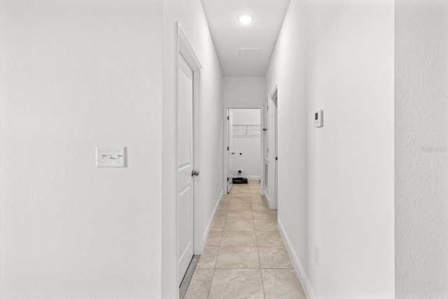 hall with light tile patterned floors