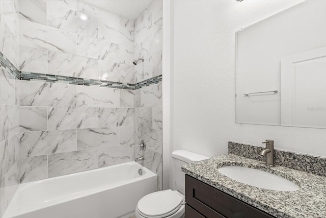 full bathroom with toilet, tiled shower / bath combo, and vanity