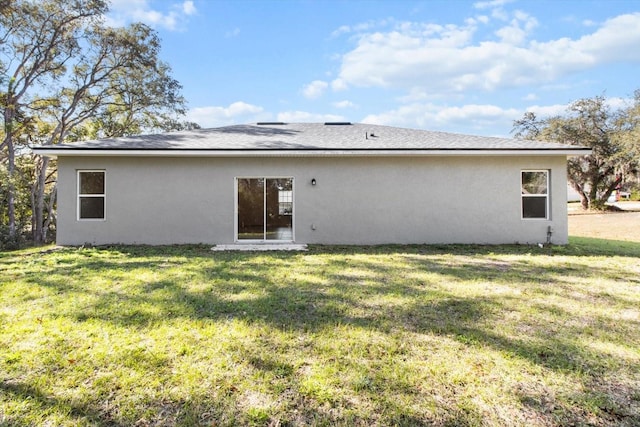 rear view of house with a lawn