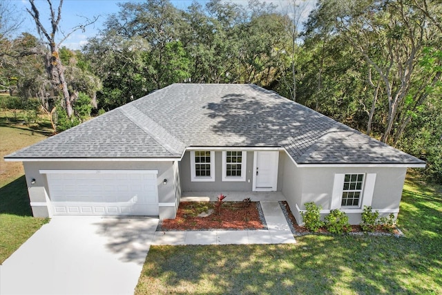 view of front facade with a front yard and a garage