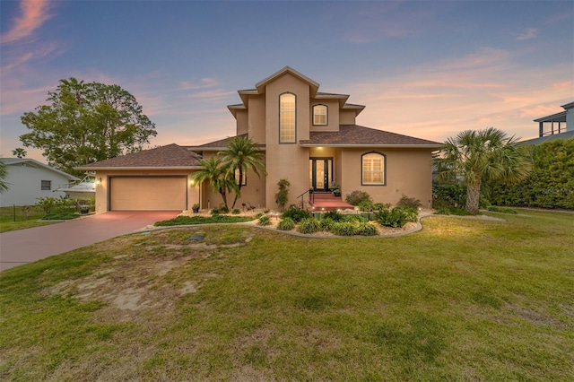 view of front of property with a yard and a garage