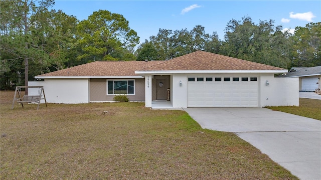 single story home featuring a front lawn and a garage