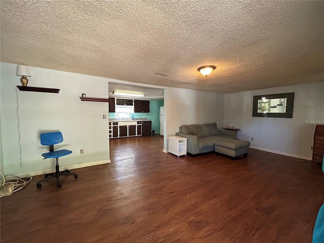 unfurnished living room featuring dark hardwood / wood-style floors and a textured ceiling