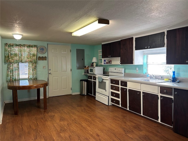 kitchen with hardwood / wood-style floors, sink, white appliances, dark brown cabinetry, and a textured ceiling