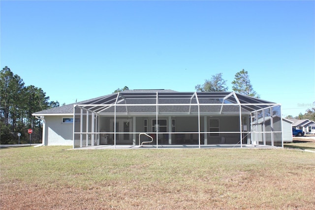 rear view of house with a lanai, a yard, and a patio