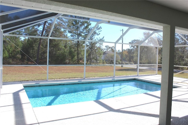 view of swimming pool featuring a lanai, a patio area, and a yard