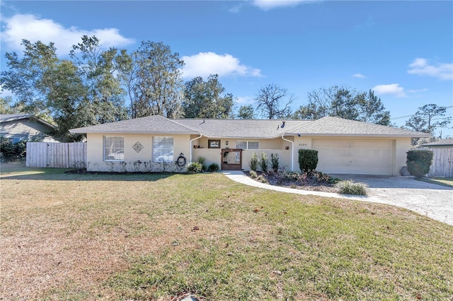 single story home featuring a garage and a front yard