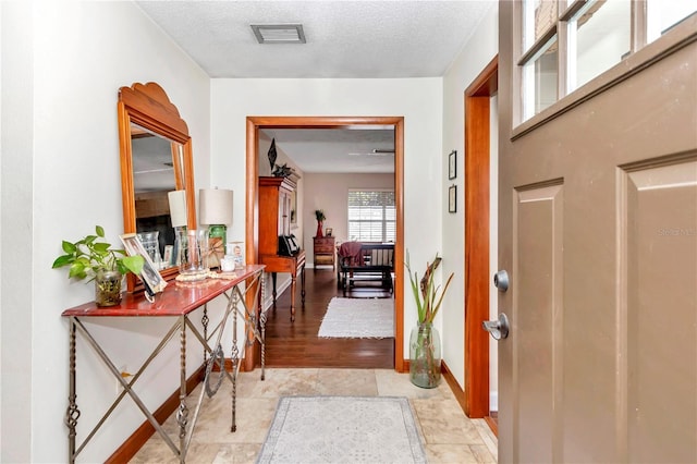 foyer with a textured ceiling