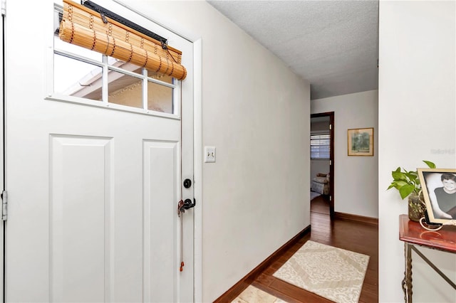 foyer with hardwood / wood-style floors and a textured ceiling