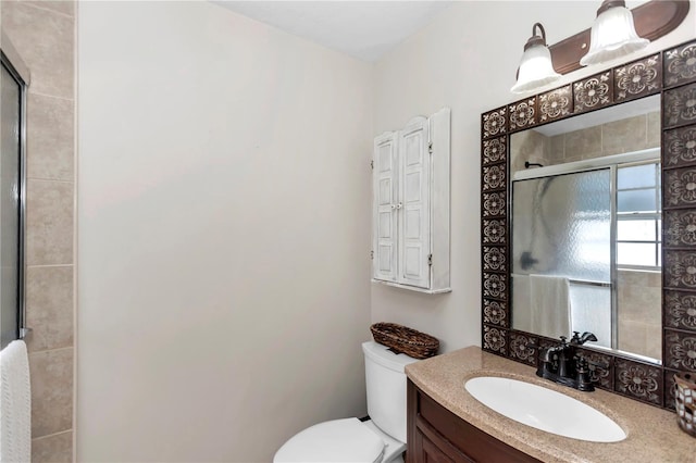 bathroom featuring vanity, toilet, and walk in shower