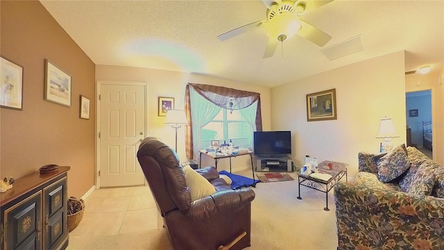 tiled living room with a textured ceiling and ceiling fan