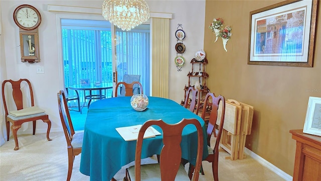 dining room featuring a chandelier and light colored carpet