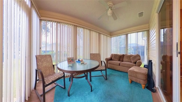 sunroom featuring ceiling fan