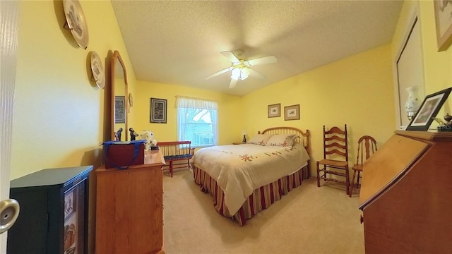 carpeted bedroom with a textured ceiling and ceiling fan