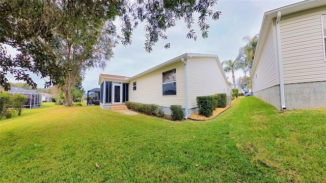 back of house with a lawn