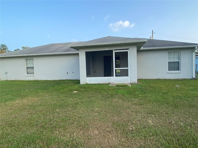 rear view of property with a yard