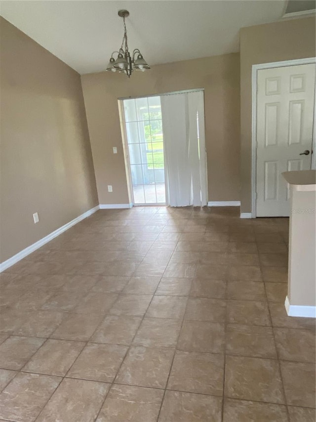 empty room featuring a notable chandelier