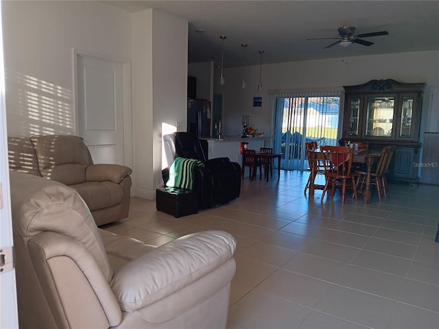 living room with ceiling fan and light tile patterned flooring