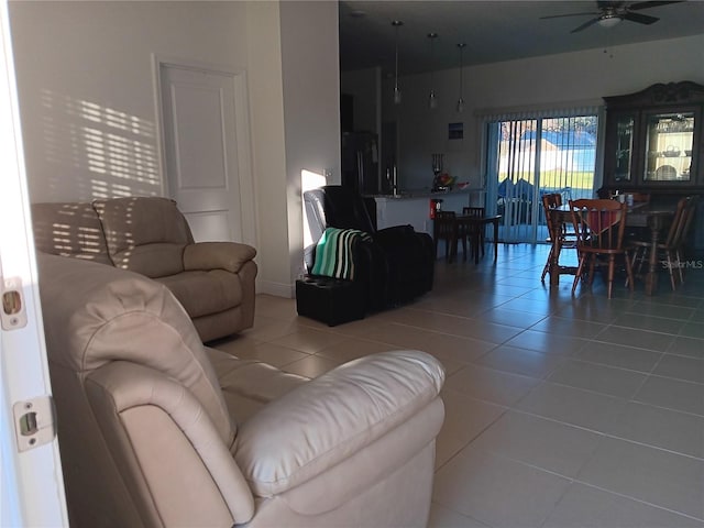 tiled living room with ceiling fan