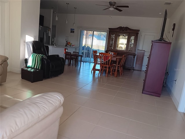 tiled living room with ceiling fan