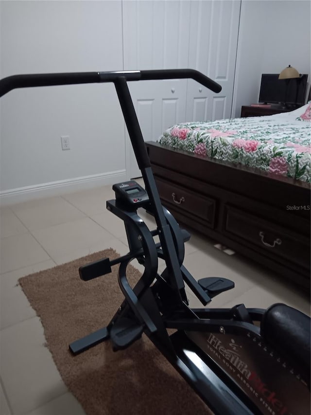 exercise area featuring light tile patterned flooring