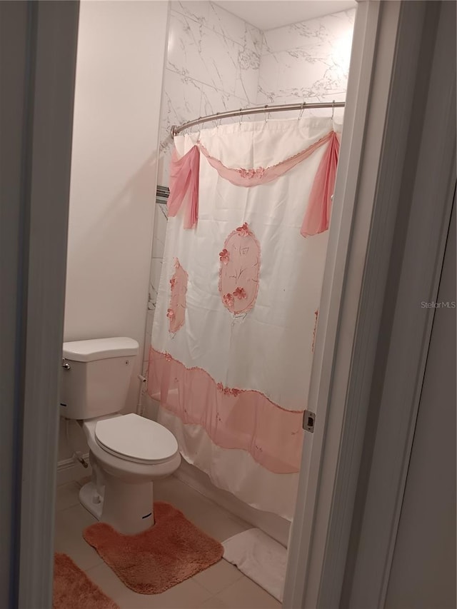 bathroom with toilet, shower / bath combination with curtain, and tile patterned floors