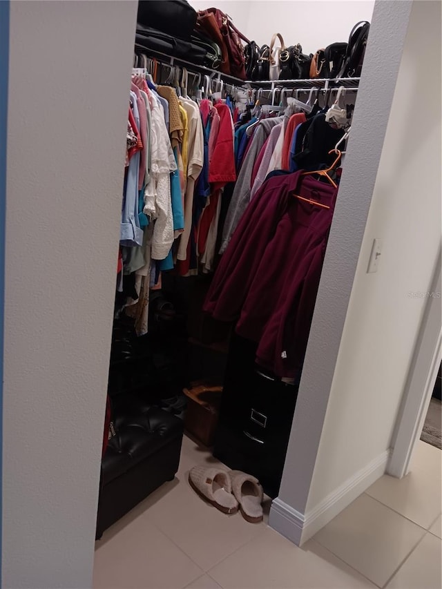 walk in closet featuring tile patterned flooring