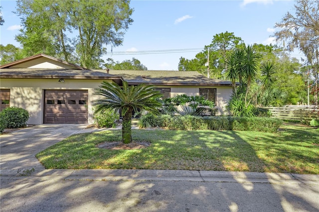 single story home featuring a front lawn and a garage