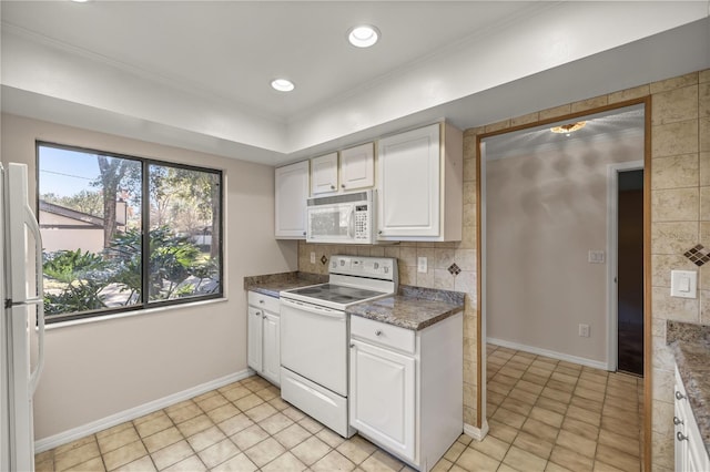 kitchen featuring white appliances, light tile patterned floors, ornamental molding, decorative backsplash, and white cabinetry