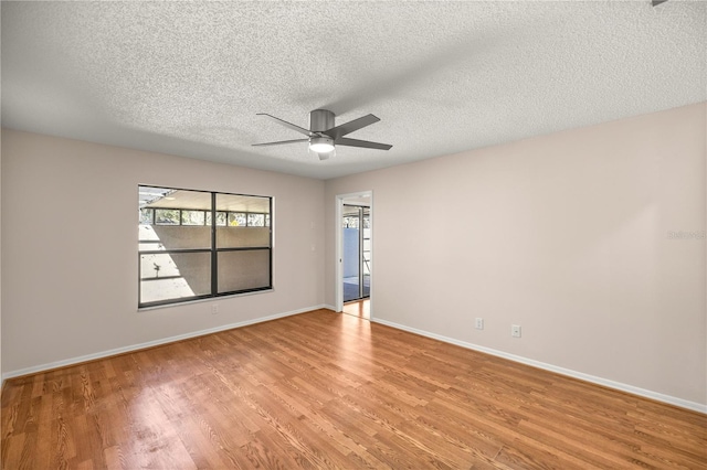 spare room with light wood-type flooring, ceiling fan, and a textured ceiling