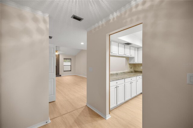 3856 NE 19th Street Cir, Ocala, FL 34470 - hallway with baseboards, visible vents, ornamental molding, and light wood-type flooring