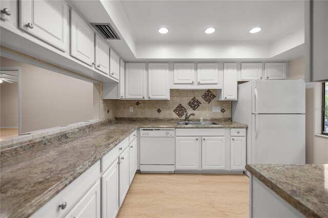 3856 NE 19th Street Cir, Ocala, FL 34470 - kitchen featuring a sink, light wood finished floors, white appliances, a tray ceiling, and visible vents
